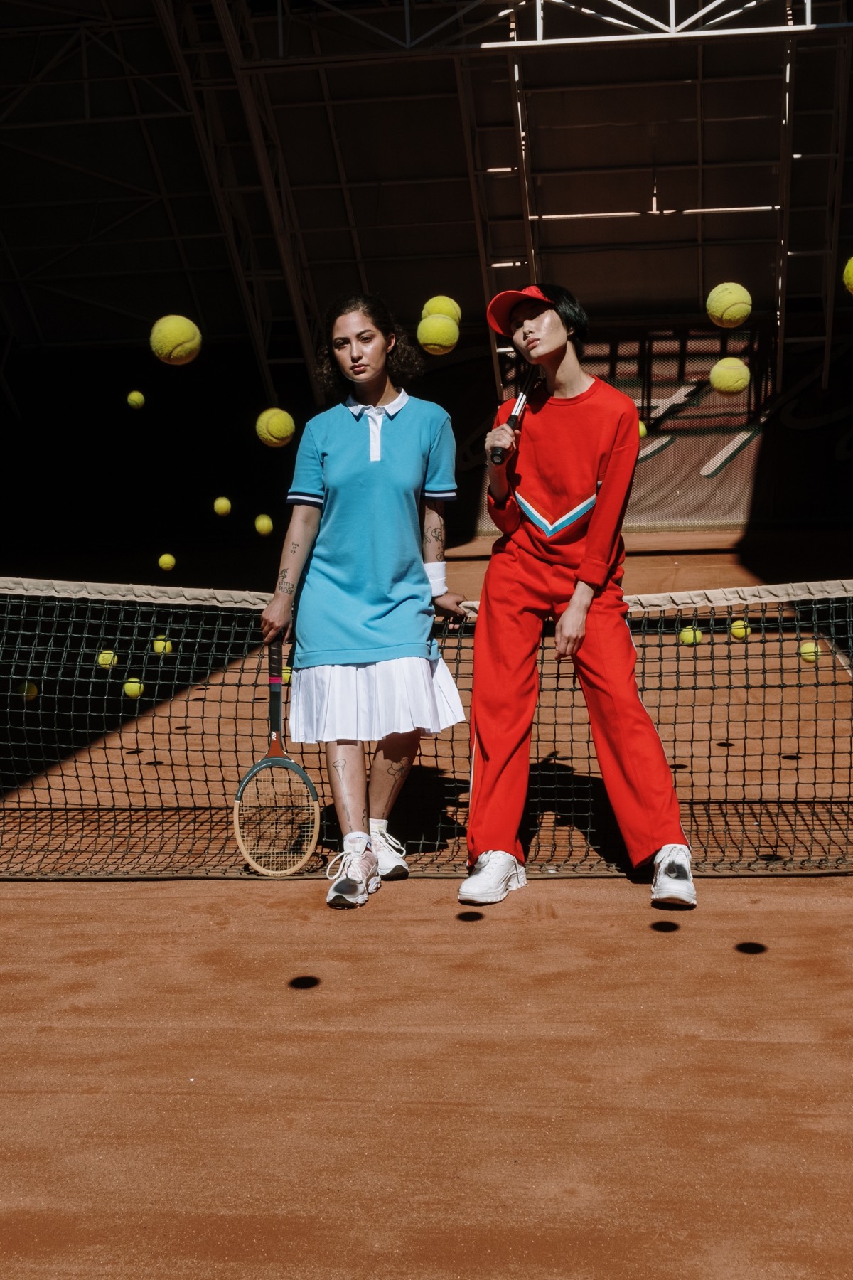 Two players on a clay court in matching athletic apparel