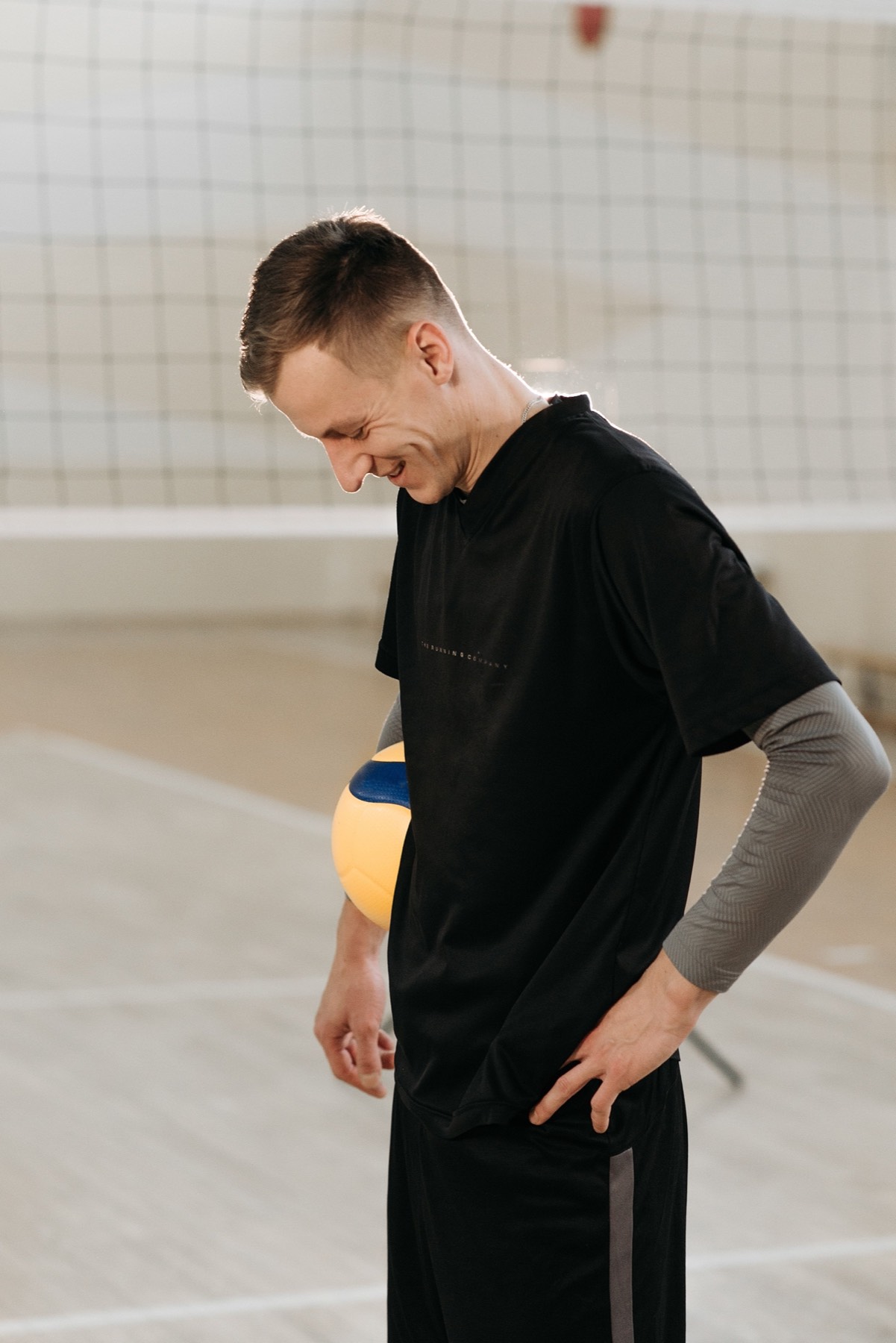 Athlete in a black training tee with arm sleeve